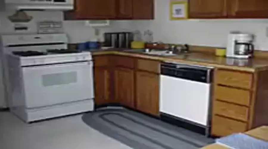 A Kitchen with overlook to dining  dining room and view  of large landscaped  back yard