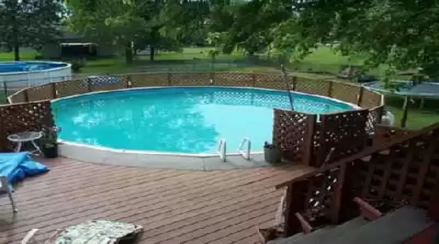 large pool in large backyard that also has a garden and horseshoe area and storage shed!