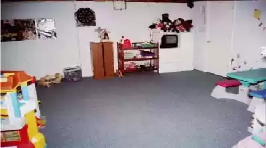 Formal dining room has space for a large table and china cabinet without being cramped!  This view of the basement show the finished area.  Beyond is room for a 4th bedroom and a laundry/storage area