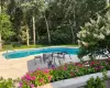 Summer photographs of pool area, outdoor patio and floral plantings