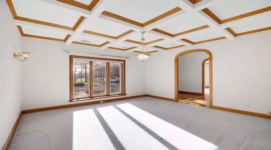 DINING ROOM WITH BEAUTIFUL COFFERED CEILING.