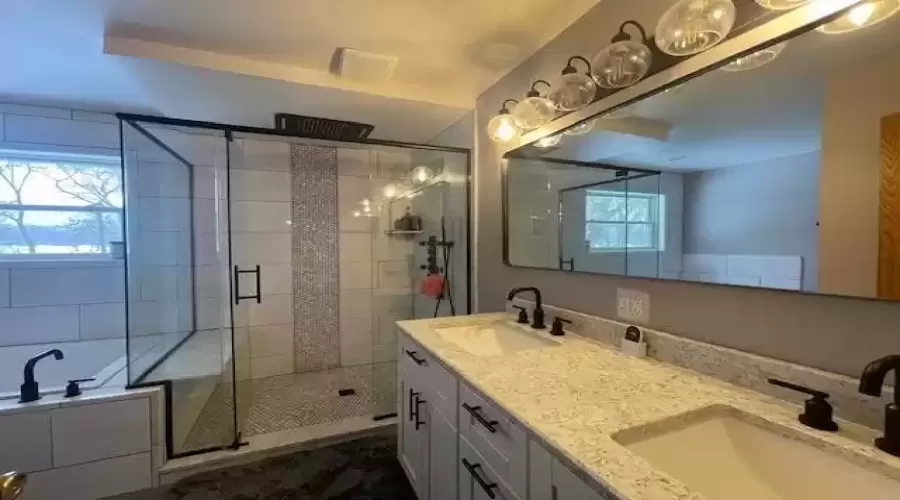 Amazing Master bath has glass doors in the shower and multiple shower heads