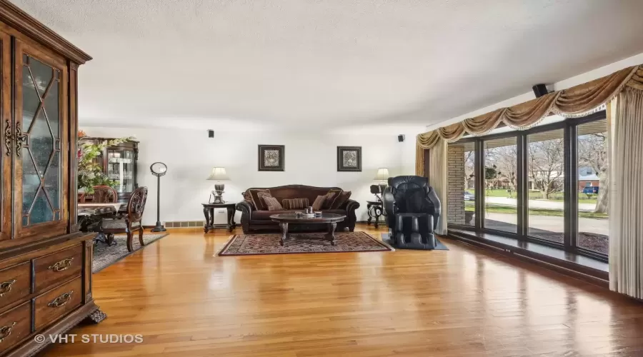 Gleaming hardwood floors seamlessly flowing into t