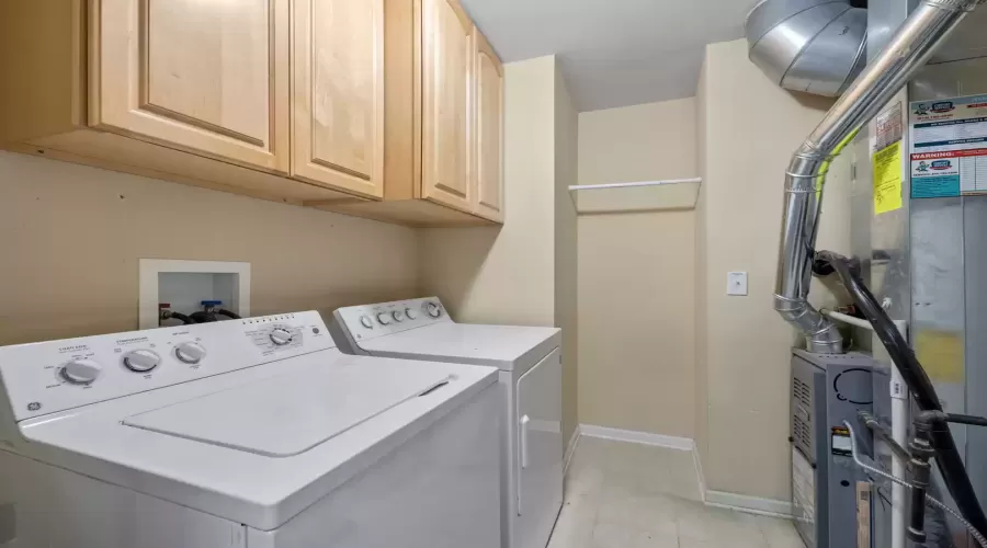 Laundry room with a full-size washer and dryer pro