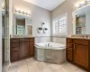 Luxurious designer tile shower with bench, dual si