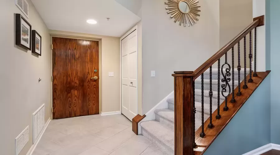 Lovely foyer with guest closet and updated stairca