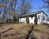 View of large backyard and back of house