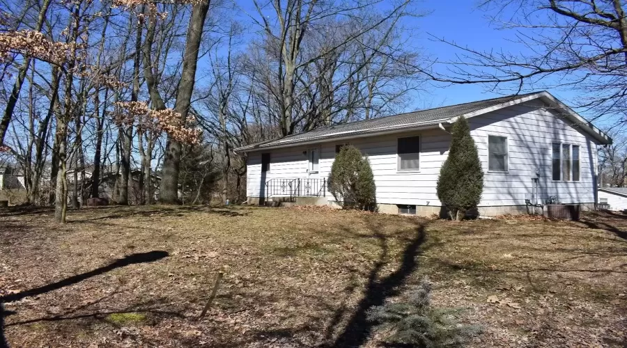 View of large backyard and back of house