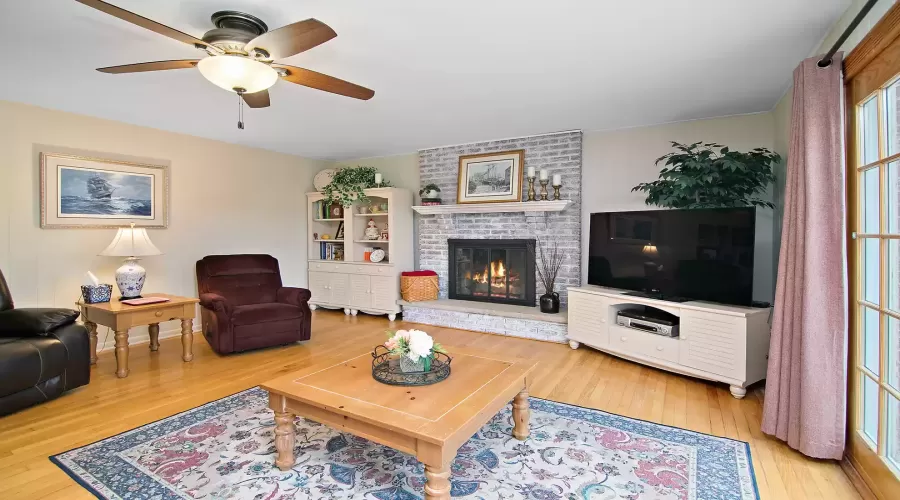 Sunlit Family Room features a Wood-Burning Firepla