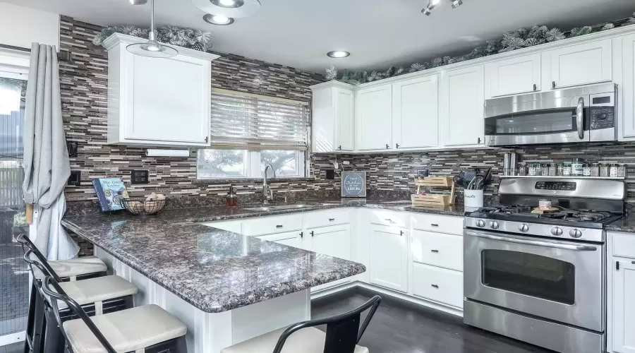 Updated white cabinetry and granite counters