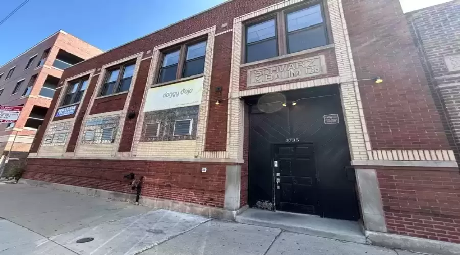 Two-story timber loft building on busy Belmont Ave